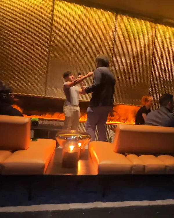 Founders talking by the fire wall in the lounge